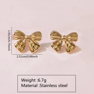 Macro view of golden bow earrings in stainless steel with exact weight and size info