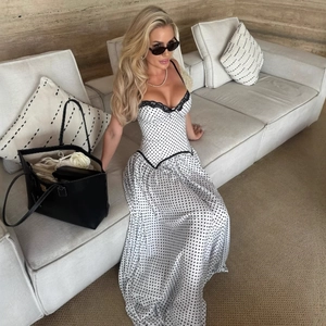 Detail of lace trim and corset style bodice on a white polka dot summer midi dress