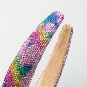 Luxury rainbow crystal headband featuring colorful rhinestones and gold fabric lining