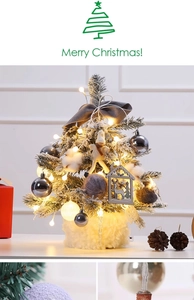 Detail of mini snow-flocked Christmas tree with gray bows and warm LED lights