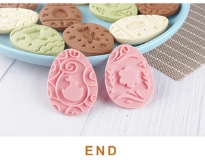 Close-up of pink plastic Easter egg cookie cutters with bunny and floral patterns