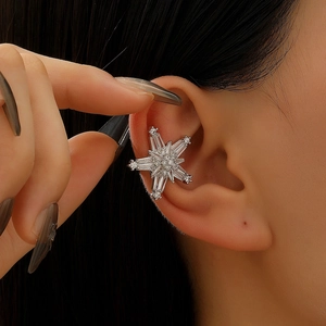 Close-up of elegant silver star-shaped ear cuff with sparkling zircon stone tassels
