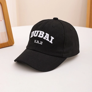 Close-up of 3D white DUBAI embroidery on black cotton canvas baseball cap