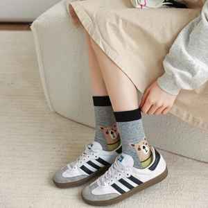 Detailed knit of heather grey crew socks featuring a cute cartoon bear motif and ribbed cuffs