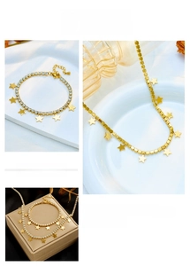 Detail view of gold star jewelry set with pavé rhinestones and polished star charms