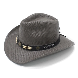 Detail of dark gray western cowboy straw hat with leather band and metal rivets