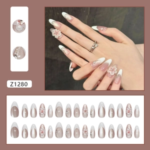 French almond press-on nails with 3D cat-eye flowers and pearls in nude pink tones