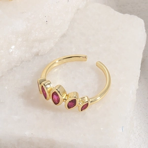 Detail of 14K gold plated ring with five pink marquise-cut zircons on crystal stone base