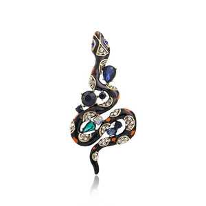 Detailed view of vintage snake brooch with black enamel and multi-color gemstones