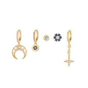 Detailed set of 5 gold moon and star huggie earrings with deep blue zircons