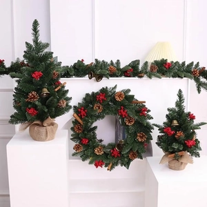 Mini Christmas tree set with red berries pine cones and bells on white stairs