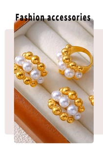 Detail view of multi-layered gold-plated stackable rings with white pearl accents
