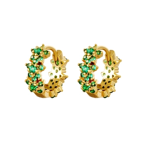 Detailed macro view of gold-plated hoop earrings featuring emerald green zircon clusters