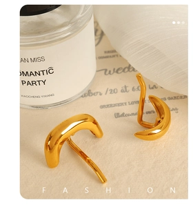 Detailed view of gold-plated abstract hair clip on elegant vintage paper background