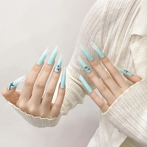 Extra long blue gradient press-on nails with palm tree silhouette and glitter accents