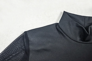 Detailed close-up of high neck stitching and black mesh sleeve on a slim fit dress