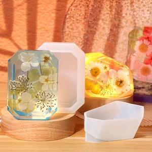 Detailed view of translucent silicone molds and crystal resin crafts with dried flowers