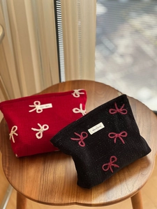 Elegant red and black velvet clutch bags with 3D bow embroidery and woven logo