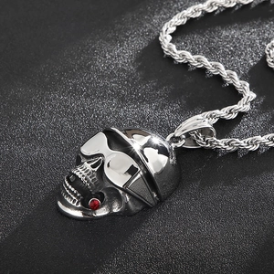 Detail of silver skull pendant with sunglasses and red tip cigar on twisted rope chain