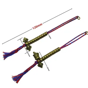 Detailed view of brass vajra pendants with dimensions and red blue woven cord tassels