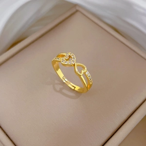 Detailed macro of heart-shaped gold ring with white zircons in a jewelry box