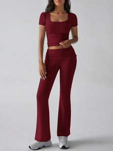 Detail view of deep red short sleeve crop top and matching high waist flared pants
