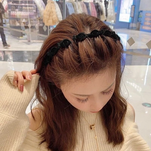 Double-layer braided headband in black fabric shown on model for a high skull top hairstyle