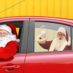 Detail of semi-transparent Santa Claus PVC car window sticker on red vehicle side