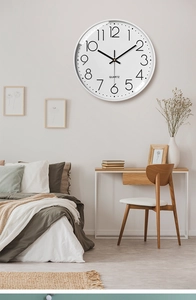 Detailed close-up of a 12-inch silent quartz wall clock in a modern Nordic bedroom setting