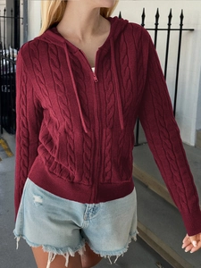 Detail of dark red cable knit hoodie cardigan showing texture and zipper closure
