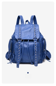Blue washed leather backpack detail showing rivet decorative straps and drawstring closure
