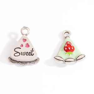 Detail view of cake and strawberry dessert alloy charms with Sweet text for DIY jewelry