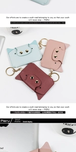 Detail of cute cat-shaped leather card holders with gold metal hardware and keychains
