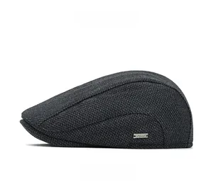 Detailed side view of dark grey newsboy cap showing tweed texture and metal logo