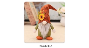 Detail of harvest gnome doll featuring a sunflower hat and autumn maple leaf elements