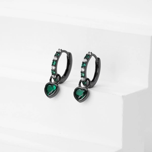 Detail shot of black heart earrings with green crystals on white minimalist stand