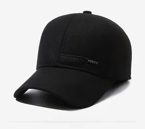 Detail shot of the black winter baseball cap featuring ear flaps and SPORT metal logo