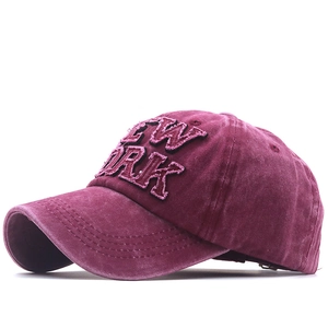 Vintage washed burgundy baseball cap with New York embroidery in 45-degree side view