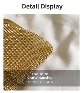 Macro shot of sparkling rhinestones and gold metal edge on a luxury evening clutch bag