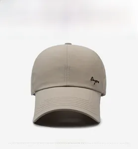 Detail of beige baseball cap featuring breathable laser-cut holes and side embroidery