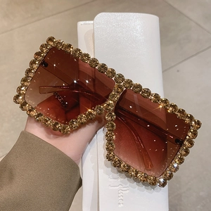 Detailed macro view of square oversized sunglasses featuring sparkling rhinestone inlay