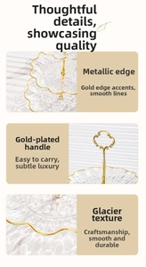 Detail of tiered glass dessert stand with gold trim, ice texture, and ring handle