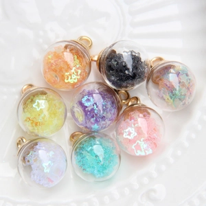 Detail of water drop glass ball pendants with colorful sequins and golden rings for DIY