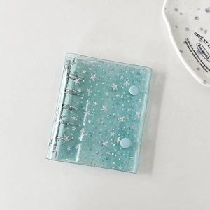 Detail of mint green laser star binder with PVC texture and silver metal loose-leaf rings