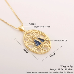 Detail of 18k gold plated necklace featuring an oval pendant with blue zircon stones