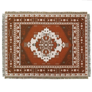 Bohemian woven blanket with Aztec geometric patterns and fringed edges for sofa or camping