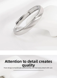 Macro shot of silver-plated open ring with twisted design and pave-set white zircons
