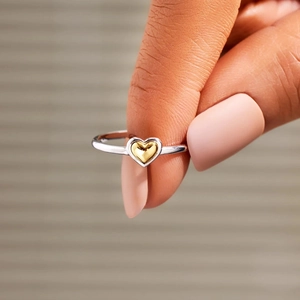 Macro detail of S925 sterling silver ring with a small gold heart-shaped inlay