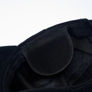 Detailed macro view of black corduroy baseball cap lining with soft velvet and elastic strap