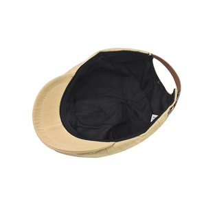 Detail view of khaki flat cap interior with sweatband and adjustable brown faux leather strap